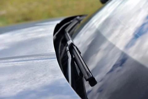 Wiper on the front windshield of a passenger car Stock Photos