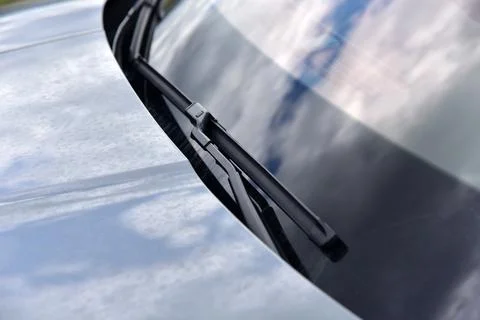 Wiper on the front windshield of a passenger car Stock Photos