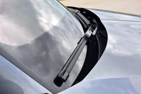 Wiper on the front windshield of a passenger car Stock Photos