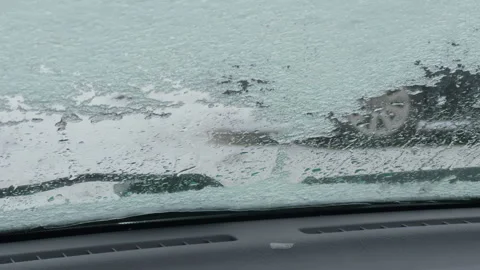Wiper stroke across wet windshield streak capturing motion, smear patterns, and Stock Footage 327825128