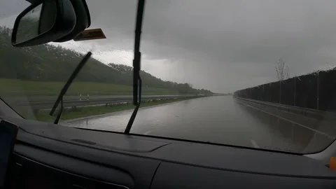 The wipers in the car keep the water out of the window when it rains Stock Footage 273890376