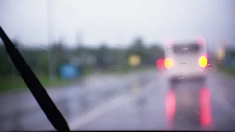 Wipers clean the windshield of a car in the rain. Stock Footage 138405271