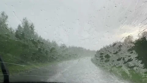 Wipers slide on wet windshield. Driving car during heavy rain. Inside view of Vídeos de archivo 156038640