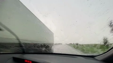 Wipers slide on wet windshield. Driving car during heavy rain. Inside view of Stock Footage 156186749
