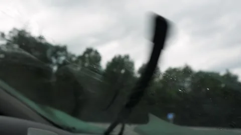 Wipers wipe windshield from raindrops Stock Footage 277114321