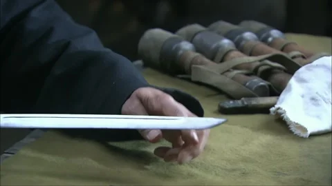 Wiping and maintaining the dagger Stock Footage 261640386