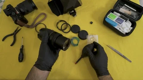 Wiping the camera lens front element with a microfiber cloth. Stock Footage 327624170