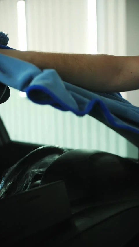 Wiping car windshield with a microfiber towel Stock Footage 296020143