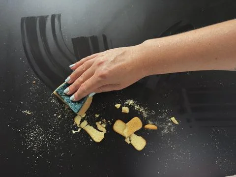 Wiping Crumbs with Sponge Stock Photos