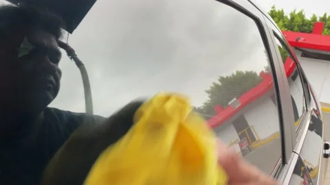 Wiping Down Side Roll Up Driver Window Video stock 210978872