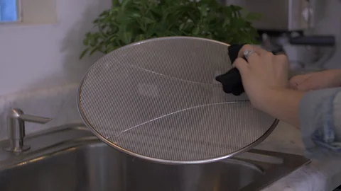 Wiping Down Splatter Guard Video stock 97784912