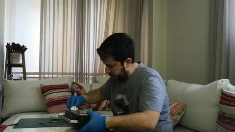Wiping down surfaces and disinfecting electronic device with cotton pads Stock Footage 130328982