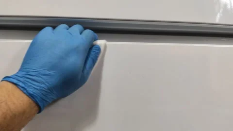 Wiping down surfaces and disinfecting electronic device with cotton pads Stock Footage 130333352