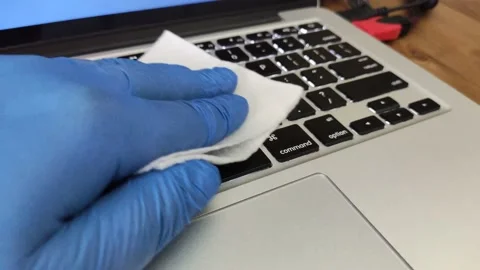 Wiping down surfaces and disinfecting electronic device with cotton pads Stock Footage 130336357