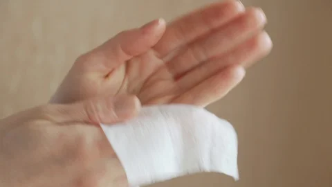 Wiping hands with wet wipe Stock Footage