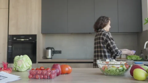 Wiping Kitchen Counter After Preparing Fresh Salad In Bright Cozy Home Stock Footage 308453851