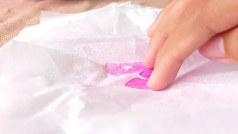 Wiping a pink liquid with a tissue Stock Footage 146253446