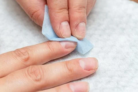 Wiping, processing nails with a special napkin before manicure Stock Photos