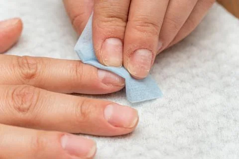 Wiping, processing nails with a special napkin before manicure Stock Photos