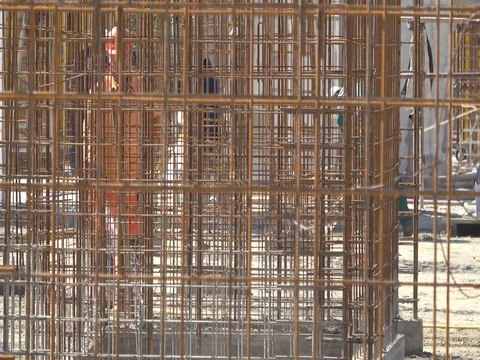 Wire armature on construction site with workers Stock Footage