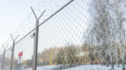 Wire barbed fence with security cctv cameras at the frontier zone on the border Stock Footage 219208960