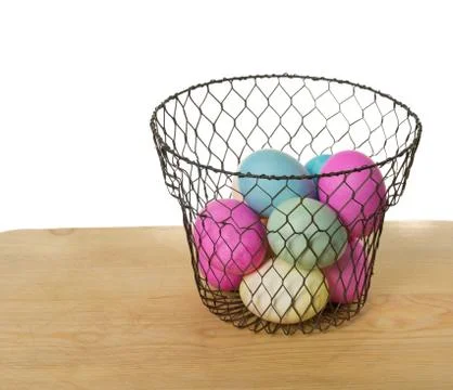 Wire basket of colored eggs Stock Photos