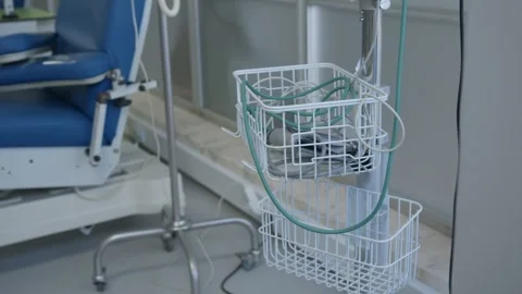 Wire Baskets and IV Pole Beside Treatment Chair in Clinic 스톡 동영상 346470198