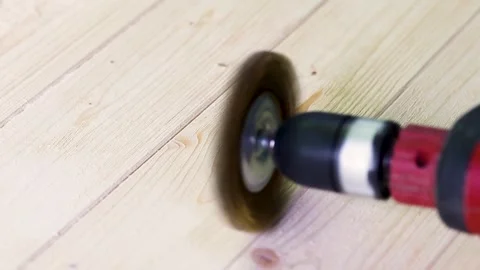 Wire brush for wood working, on a drill. Female hand is holding brushing machine Stock Footage 244936094