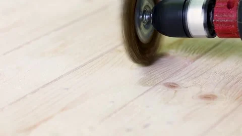 Wire brush for wood working, on a drill. Female hand is holding brushing machine Stock Footage 245986080