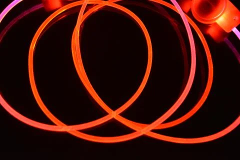 Wire, cable, polyethylene tubes, rods with red, orange, yellow, pink light. 스톡 사진