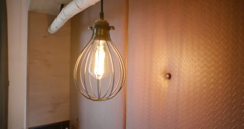 Wire Cage Pendant Light With Filament Bulb Glows On Wood Wall Видео 340265820