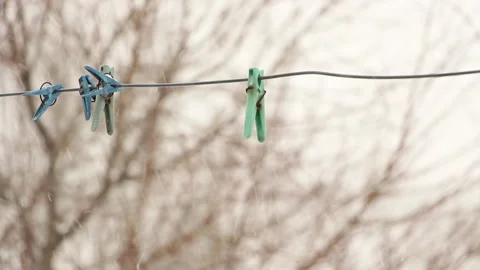 Wire with clothes pegs in winter time Stock Footage 87647001