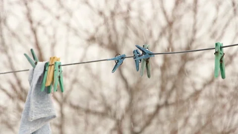 Wire with clothes pegs in winter time Stock Footage 87988610
