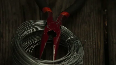 Wire Coil Being Picked Up With Pliers Stock Footage 73436880
