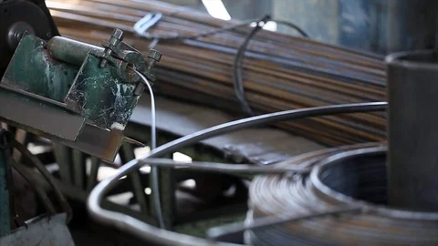 Wire coil rotates on cutting machine on concrete factory Stock Footage 70208286