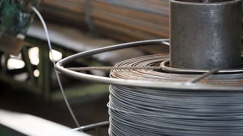 Wire coil rotates on cutting machine on concrete factory Stock Footage 70208295