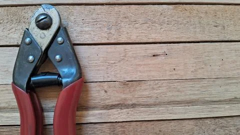 Wire cutter tool on wood background. Industrial steel pliers for cutting Stock Photos