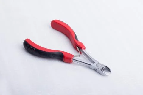 A wire cutter on a white surface Stock Photos