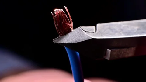 Wire cutters cutting multi-strand copper electrical wire Stock Footage 345712618