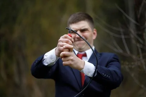 Wire cutters. Man in jacket cuts wires with pliers Stock Photos