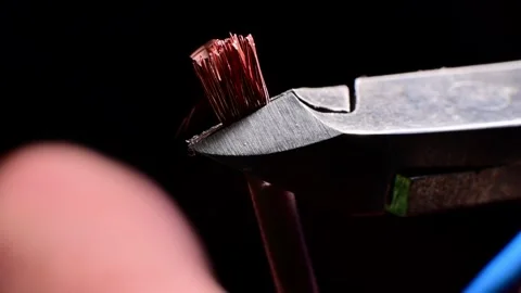 Wire cutters trimming copper strands in macro slow motion Stock Footage 345385461