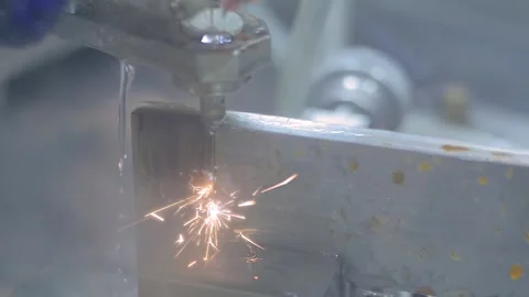Wire cutting machine working with metal workpiece with sparks - slow motion Stock Footage 138031400