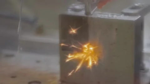 Wire cutting machine working with metal workpiece with sparks at factory Stock Footage 170336813