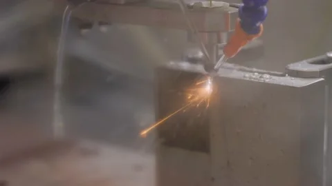 Wire cutting machine working with metal workpiece with sparks at factory Stock Footage 205373894