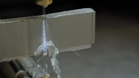 Wire cutting machine working with metal workpiece with sparks at factory Stock Footage 217413047
