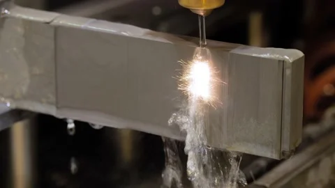 Wire cutting machine working with metal workpiece with sparks at factory Stock Footage 233901429