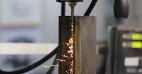 Wire EDM cutting of metal workpiece with sparks in industrial machine. Stock Footage 343408617
