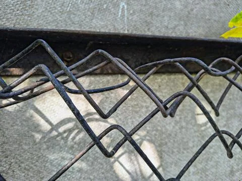 Wire fence. chain link mesh. rusty iron fence. old rusty cage. symbol of fr.. Stock Photos
