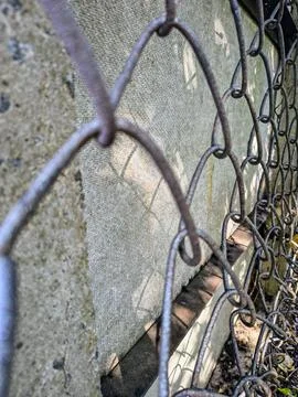 Wire fence. chain link mesh. rusty iron fence. old rusty cage. symbol of fr.. Stock Photos