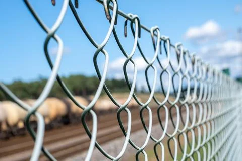 A wire fence separates the freight train. Copy space Stock Photos